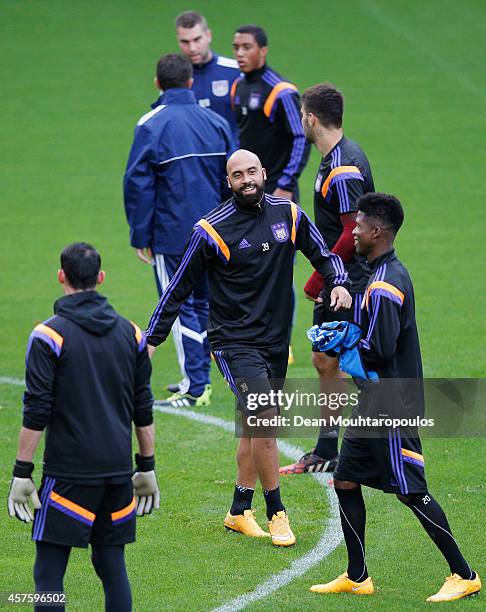 Anthony Vanden Borre jokes with team mates during the R.S.C. Anderlecht training session held at Constant Vanden Stock Stadium on October 21, 2014 in...