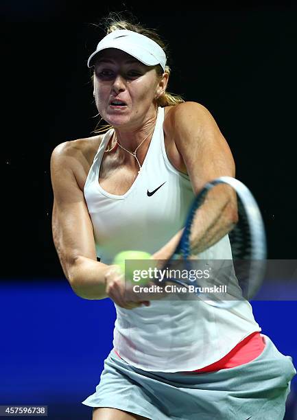 Maria Sharapova of Russia plays a backhand against Caroline Wozniacki of Denmark in their round robin match during the BNP Paribas WTA Finals at...
