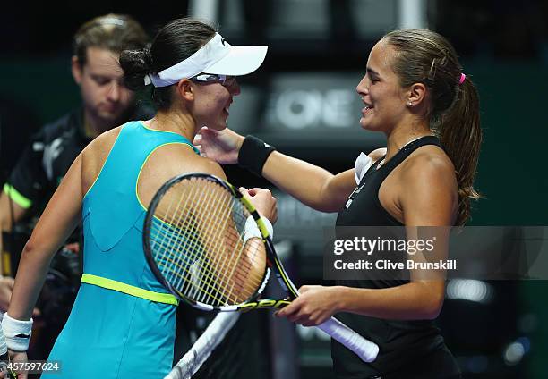 Monica Puig of Puerto Rico shakes hands at the net after her two set victory against Saisai Zheng of China in the WTA Rising Stars final during the...