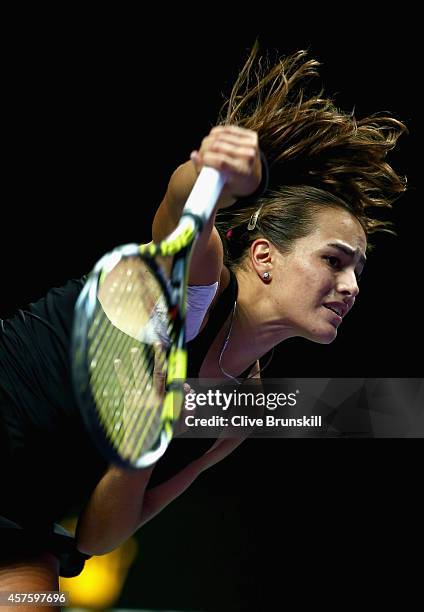 Monica Puig of Puerto Rico serves against Saisai Zheng of China in the WTA Rising Stars final during the BNP Paribas WTA Finals at Singapore Sports...