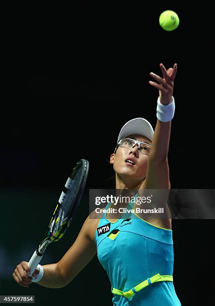 Saisai Zheng of China serves against Monica Puig of Puerto Rico in the WTA Rising Stars final during the BNP Paribas WTA Finals at Singapore Sports...