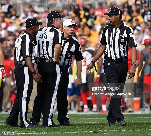 National Football League referee Walt Anderson confers with back judge Terrence Miles , umpire Jeff Rice and line judge Byron Boston during a game...