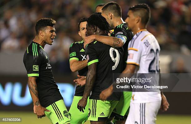 DeAndre Yedlin , Marco Pappa and Clint Dempsey of Seattle Sounders FC congratulate jubilant teammate Obafemi Martins after Martins scored a goal to...