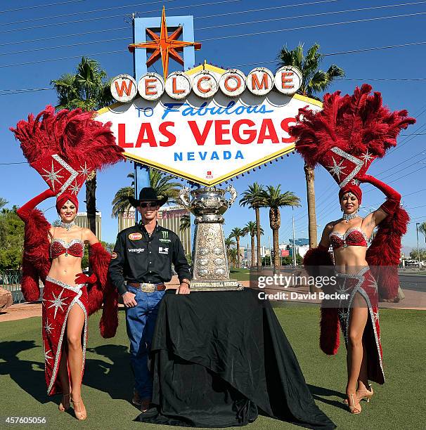 Professional bull rider J.B. Mauney and Las Vegas showgirls pose with the Professional Bull Riders' championship trophy at the kick off to the 21st...