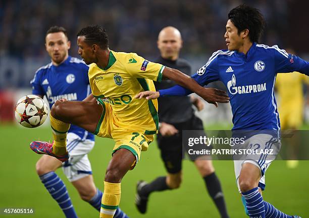 Schalke's Japanese defender Atsuto Uchida and Sporting´s Nani vie for the ball during the first leg UEFA Champions League Group G football match FC...