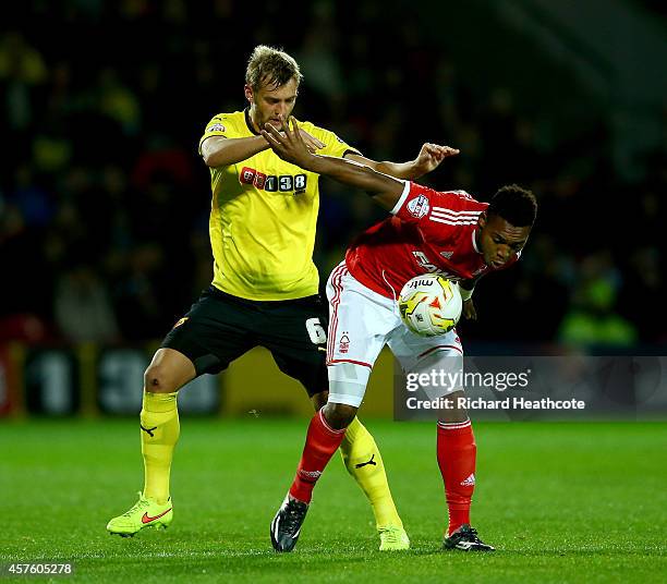 Britt Assombalonga of Forest holds off Joel Ekstrand of Watford during the Sky Bet Championship match between Watford and Nottingham Forest at...