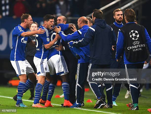 Chinedu Obasi of Schalke celebrates scoring their first goal with team mates and Roberto Di Matteo, the manager of Schalke during the UEFA Champions...