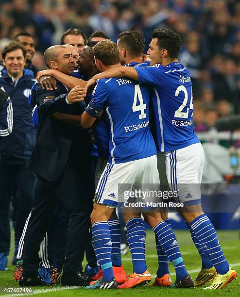 Chinedu Obasi of Schalke celebrates scoring their first goal with team mates and Roberto Di Matteo, the manager of Schalke during the UEFA Champions...