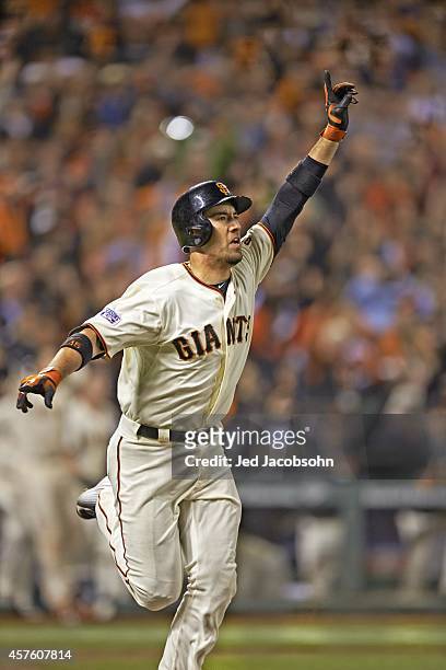 Playoffs: San Francisco Giants Travis Ishikawa victorious after hitting game winning, walk-off home run to win Game 5 and series vs St. Louis...