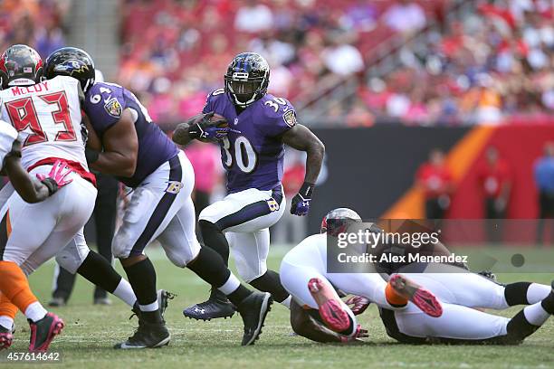 Running back Bernard Pierce of the Baltimore Ravens runs the football during an NFL football game at Raymond James Stadium on October 12, 2014 in...