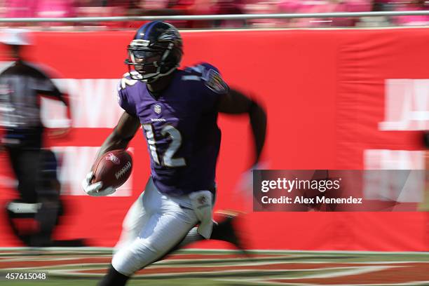 Wide receiver Jacoby Jones of the Baltimore Ravens runs the football during an NFL football game at Raymond James Stadium on October 12, 2014 in...