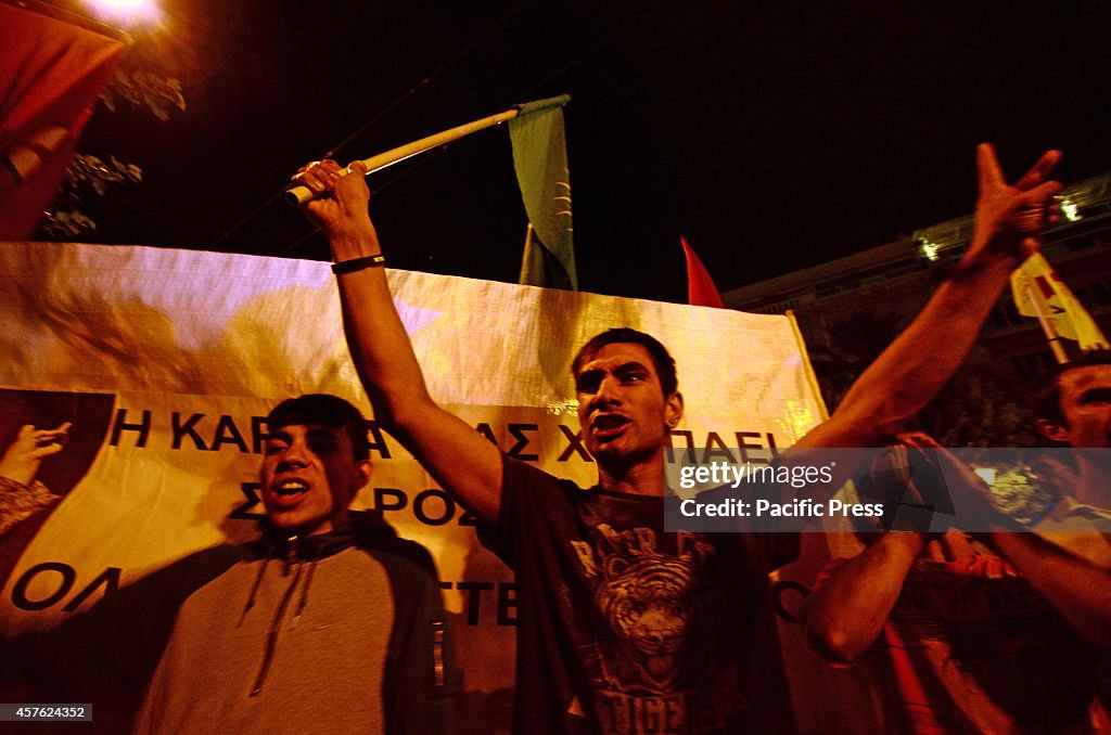 Demonstrators stand in front of the E.U. offices in Athens...