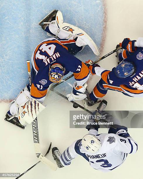 Jaroslav Halak of the New York Islanders makes a second period save on Dion Phaneuf of the Toronto Maple Leafs at the Nassau Veterans Memorial...