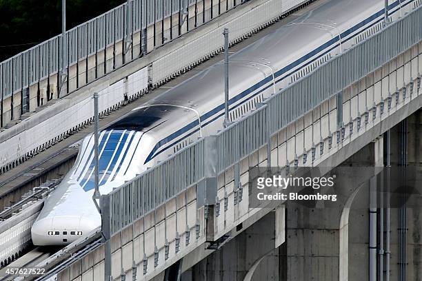 An L0 series magnetic levitation train, developed by Central Japan Railway Co., travels along on an elevated track during a trial run at the...