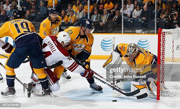 Joe Vitale of the Arizona Coyotes has his shot blocked by goalie Pekka Rinne as Roman Josi of the Nashville Predators defends at Bridgestone Arena on...