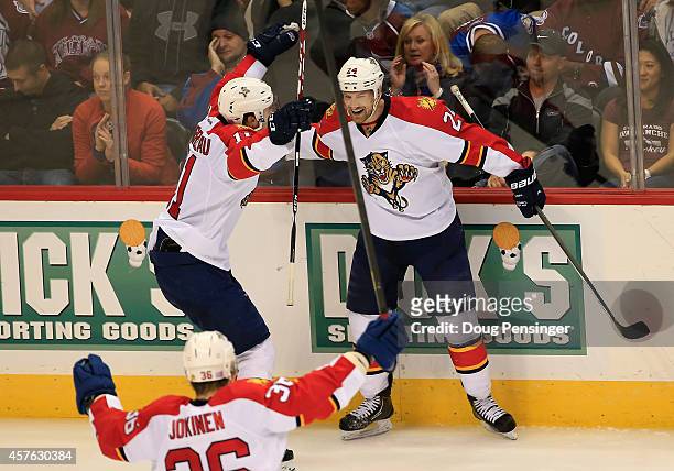 Brad Boyes of the Florida Panthers celebrates his game winning goal in overtime with Jonathan Huberdeau and Jussi Jokinen of the Florida Panthers...