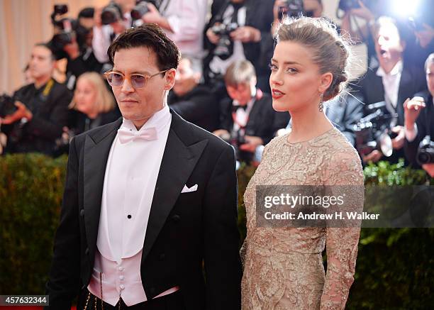 Johnny Depp and Amber Heard attend the "Charles James: Beyond Fashion" Costume Institute Gala at the Metropolitan Museum of Art on May 5, 2014 in New...