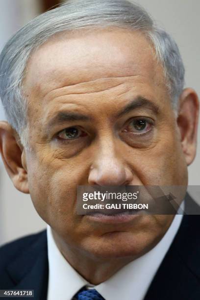 Israeli Prime Minister Benjamin Netanyahu looks on as he chairs the weekly cabinet meeting on October 22, 2014 at his Jerusalem office. Israeli and...