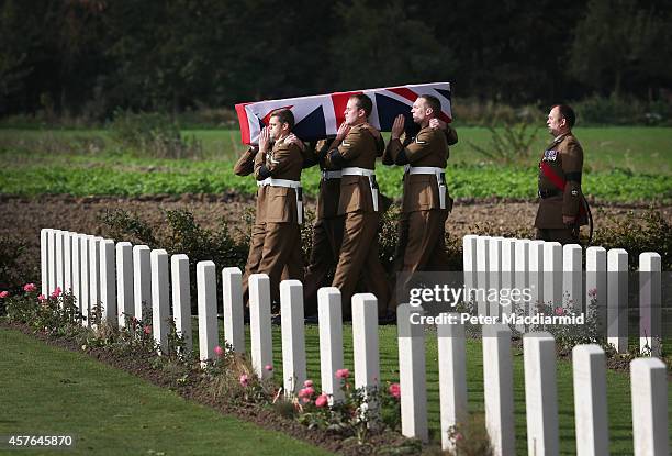 Members of the 4th Battalion The Yorkshire Regiment carry a flag draped coffin containing the remains of a World War One soldier during a re-burial...