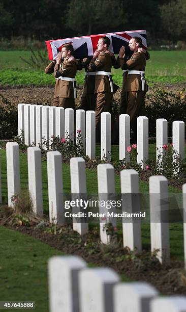 Members of the 4th Battalion The Yorkshire Regiment carry a flag draped coffin containing the remains of a World War One soldier during a re-burial...