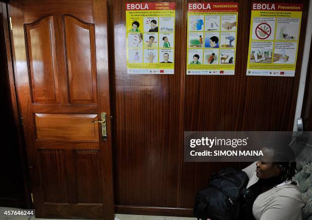 Poster carrying information on prevention and handling of suspected Ebola casesis displayed at a government building October 22, 2014 in Nairobi....