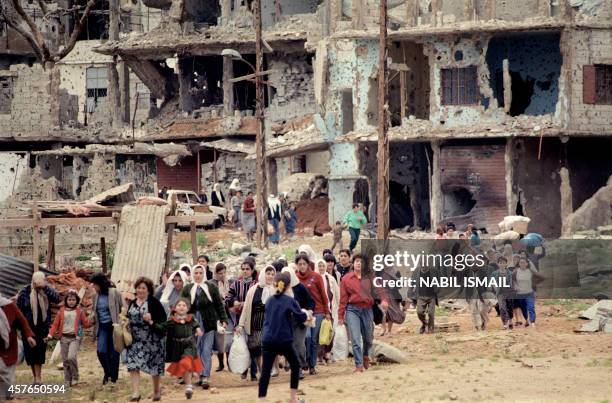 Dozens of Palestinian women leave the Bourj Barajneh refugee camp in Beirut southern suburb 25 March 1987, to look for some food at the nearby...