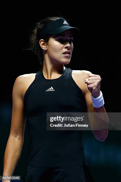 Ana Ivanovic of Serbia celebrates a point against Eugenie Bouchard of Canada during day three of the BNP Paribas WTA Finals tennis at the Singapore...