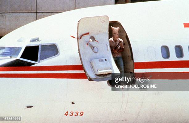 One of the two heavily armed Lebanese Shiite militants who hijacked a TWA Boeing 727 passenger aircraft at Beirut Airport looks out from the...