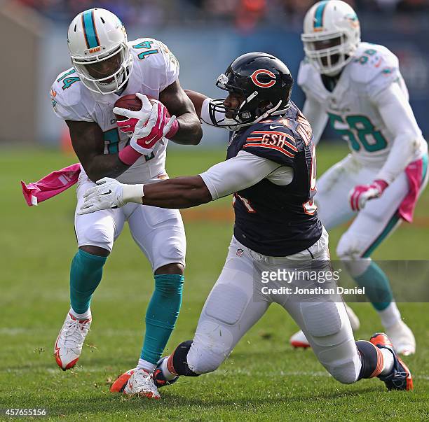 Jarvis Landry of the Miami Dolphins breaks away from Cornelius Washington of the Chicago Bears at Soldier Field on October 19, 2014 in Chicago,...