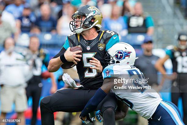 Blake Bortles of the Jacksonville Jaguars is tackled by Marqueston Huff of the Tennessee Titans at LP Field on October 12, 2014 in Nashville,...