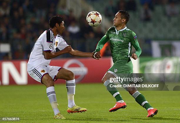 Basel's Egyptian midfielder Mohamed Elneny vies for the ball with Ludogorets Razgrad's midfielder from Brazil Marcelinho during the UEFA Champions...