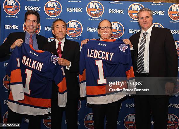 New York Islanders partners Scott Malkin, Charles Wang and Jon Ledecky, along with general manager Garth Snow pose for a photo opportunity during a...