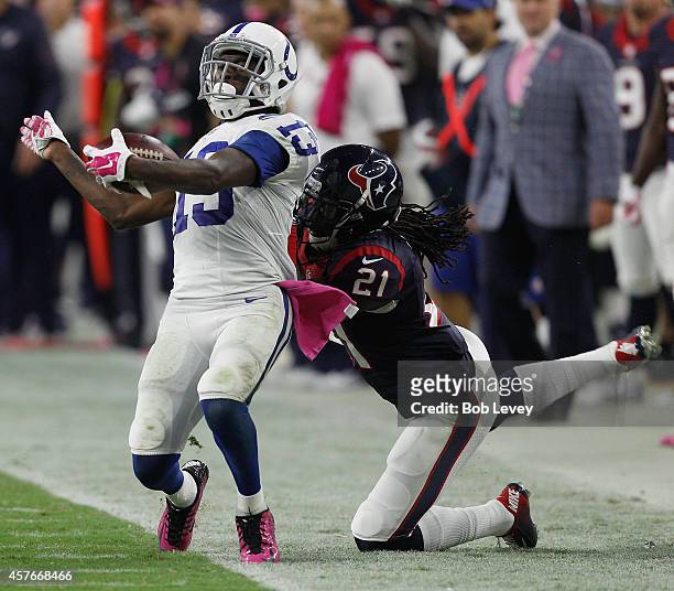 Hilton of the Indianapolis Colts is tackled by Kendrick Lewis of the Houston Texans during game action at Reliant Stadium on October 9, 2014 in...