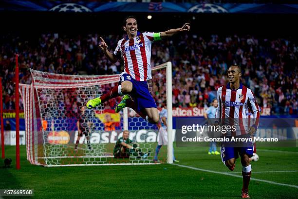 Diego Godin jumps to celebrate scoring their fourth goal close to his team mate Joao Miranda during the UEFA Champions League group A match between...