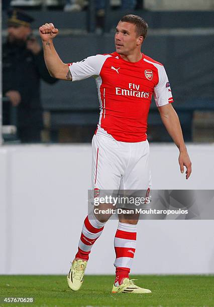 Lukas Podolski of Arsenal celebrates as he scores their second goal during the UEFA Champions League Group D match between RSC Anderlecht and Arsenal...