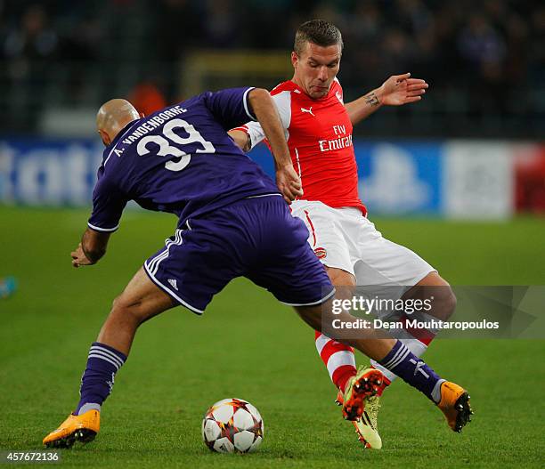 Anthony Vanden Borre of Anderlecht battles with Lukas Podolski of Arsenal during the UEFA Champions League Group D match between RSC Anderlecht and...