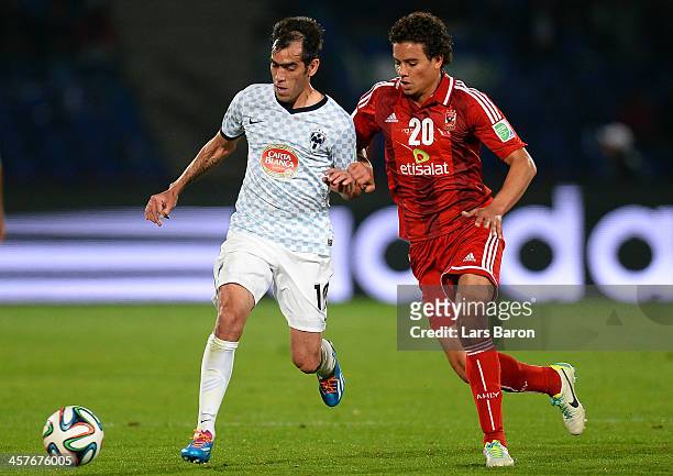 Cesar Delgado of Monterrey is challenged by Saadeldin Saad of AlAhly during the FIFA Club World Cup 5th place match between Al Ahly SC and CF...