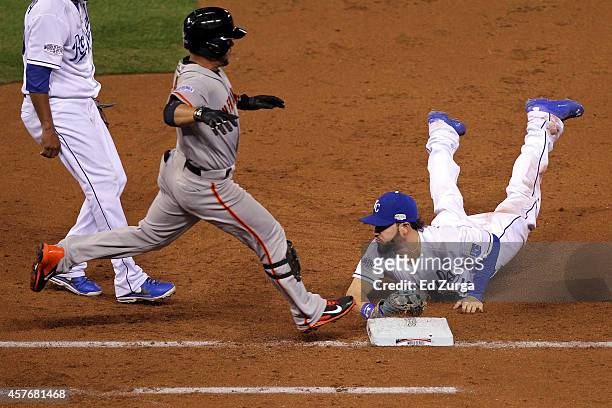 Eric Hosmer of the Kansas City Royals dives to tag out Gregor Blanco of the San Francisco Giants in the third inning during Game Two of the 2014...