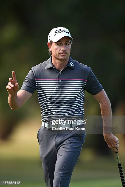 Brett Rumford of Australia acknowledges the gallery after birdying the 16th hole during day one of the 2014 Perth International at Lake Karrinyup...