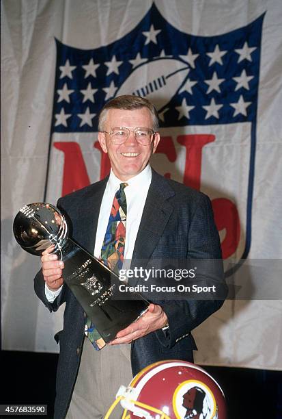 Head Coach Joe Gibbs of the Washington Redskins holds onto the Vince Lombardi Trophy after they defeated the Buffalo Bills in Super Bowl XXVI at the...