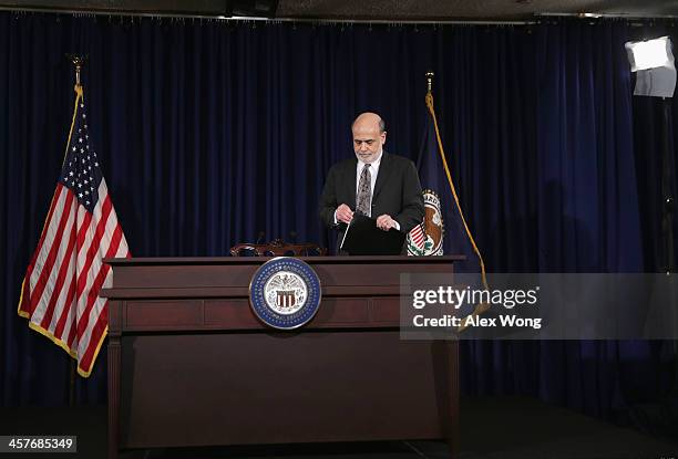 Federal Reserve Board Chairman Ben Bernanke takes his seat at a news conference after a Federal Open Market Committee meeting December 18, 2013 at...