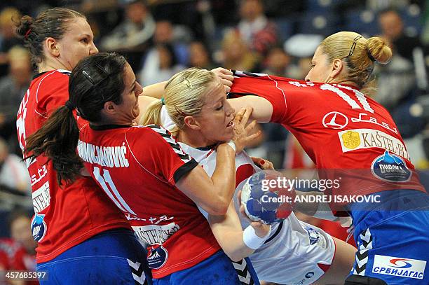 Norway's Heidi Loke vies with Serbia's Dragana Cvijic , Sanja Damnjanovic and Sanja Rajovic during their Women's 2013 Handball World Championship...