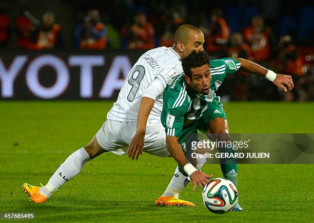 Morocco Raja Casablanca's defender Adil Karrouchy fights for the ball against Brazil Atletico Mineiro's forward Diego Tardelli during their...
