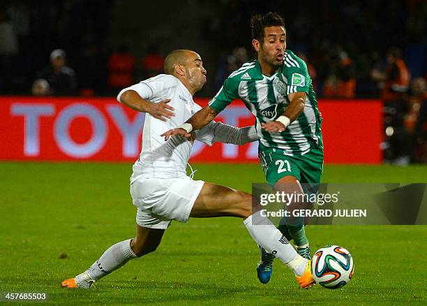 Morocco Raja Casablanca's defender Adil Karrouchy fights for the ball against Brazil Atletico Mineiro's forward Diego Tardelli during their...