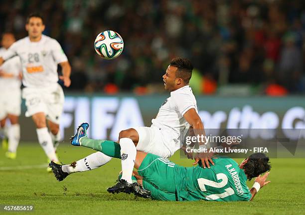 Fernandinho of Atletico Mineiro is tackled by Adil Karrouchy of Raja Casablanca during the FIFA Club World Cup Semi Final match between Raja...