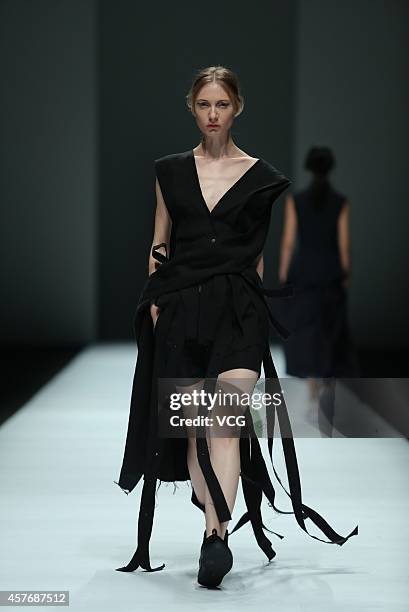 Model showcases designs on the runway at Haizhen Wang show during the Shanghai Fashion Week 2015 Spring/Summer on October 22, 2014 in Shanghai, China.