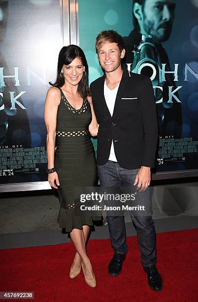 Actors Perrey Reeves and Aaron Fox attend Summit Entertainment's premiere of "John Wick" at the ArcLight Hollywood on October 22, 2014 in Hollywood,...