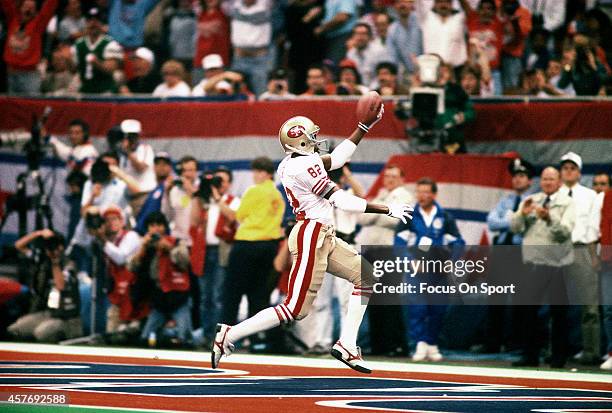 John Taylor of the San Francisco 49ers scores a touchdown against the Denver Broncos during Super Bowl XXIV on January 28, 1990 at the Super Dome in...