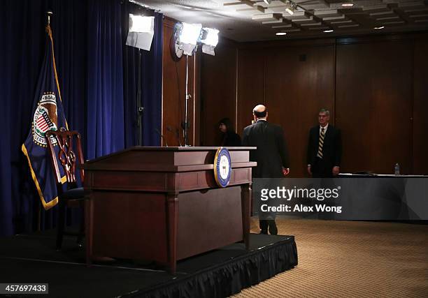 Federal Reserve Board Chairman Ben Bernanke leaves after a news conference after a Federal Open Market Committee meeting December 18, 2013 at the...