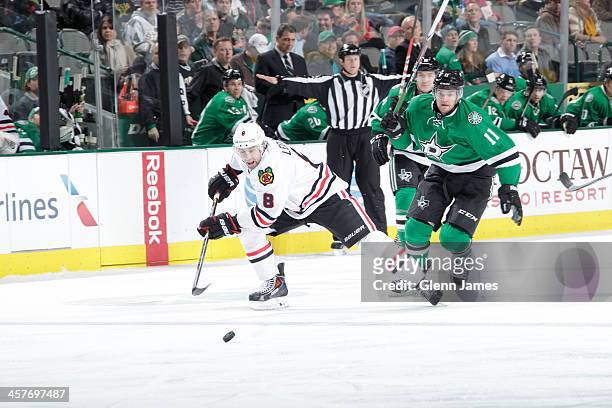 Nick Leddy of the Chicago Blackhawks tries to keep the puck away against Dustin Jeffrey of the Dallas Stars at the American Airlines Center on...